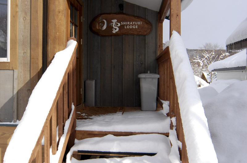 Shirayuki Lodge Entrance Up Stairs with Snow | East Hirafu
