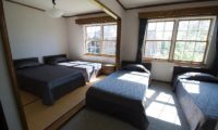 Snowgum Lodge Bedroom with Quad Beds | East Hirafu