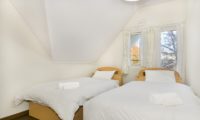 Powderhound Lodge Twin Bedroom with Wooden Floor | Upper Hirafu