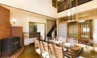 Powderhound Lodge Dining Area Near Fireplace | Upper Hirafu