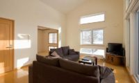 Ruby Chalet Living Area with TV and Wooden Floor | East Hirafu