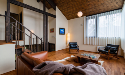 Tahoe Lodge Lounge Room with Wooden Floor and Hanging Lamp | East Hirafu
