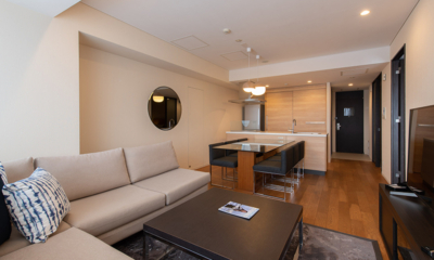Chatrium Niseko Two Bedroom Apartment Living, Kitchen and Dining Area with TV | Upper Hirafu