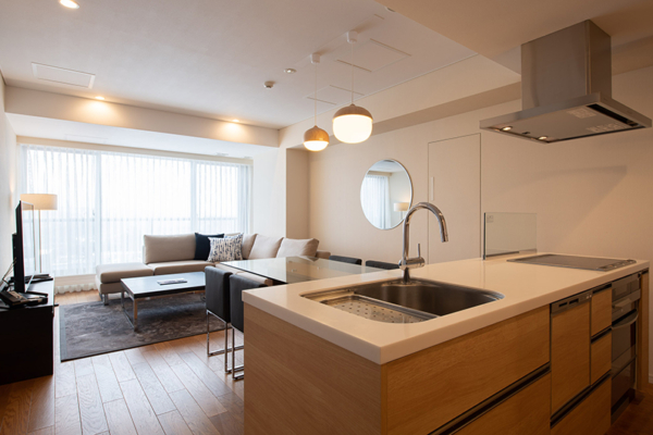Chatrium Niseko Two Bedroom Apartment Living, Kitchen and Dining Area with Hanging Lights | Upper Hirafu