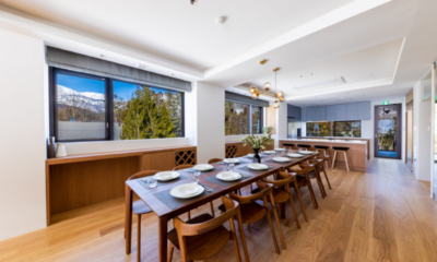 Roka five bedroom penthouse dining table with breakfast bar in background, forest and mountain views | Happo Village, Hakuba