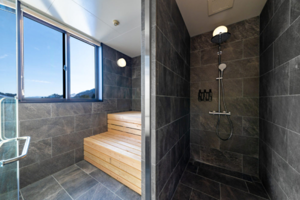 Roka five bedroom penthouse grey tile rain shower steam sauna with ski slope views | Happo Village, Hakuba