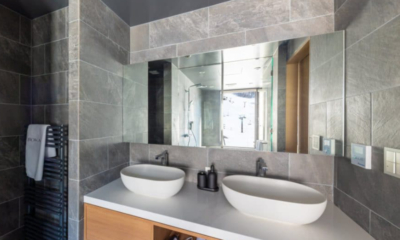 Roka five bedroom penthouse bathroom grey tile with two washstands, ski slope view | Happo Village, Hakuba