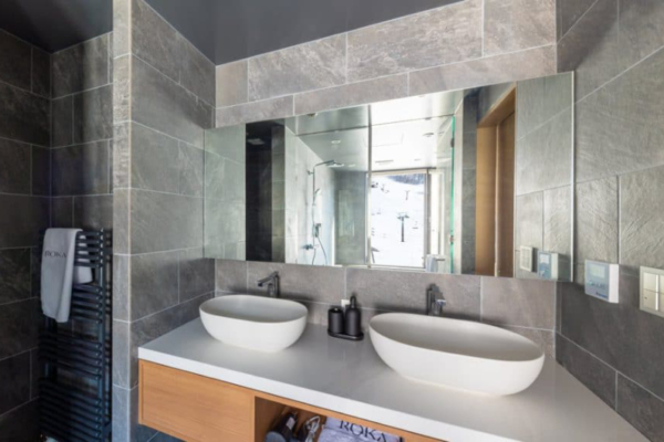 Roka five bedroom penthouse bathroom grey tile with two washstands, ski slope view | Happo Village, Hakuba