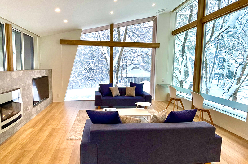Sanzan living room with fireplace, snowy scenery | Echoland, Hakuba