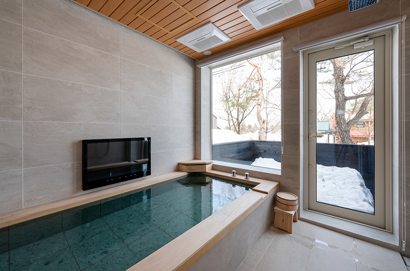 Silver Maple Chalet feature bath onsen style tub with flat-screen TV | Echoland, Hakuba