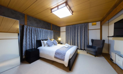 The Castle | Bedroom one with double bed, armchair | Echoland, Hakuba