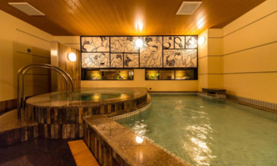 The Happo onsen hot spring interior alternate bath with decorative wall print | Happo Village, Hakuba