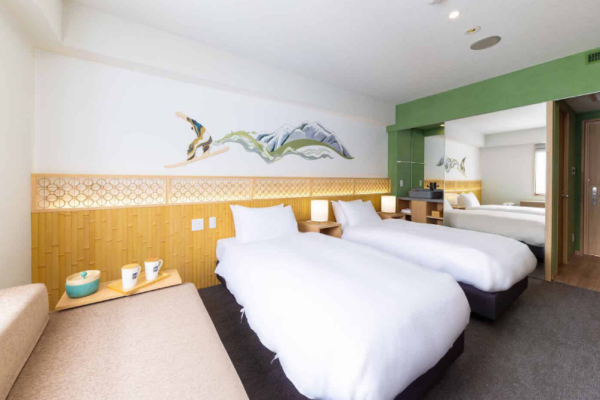 The Happo deluxe hotel room - two twin beds, sofa day bed, view of en suite bathroom and entrance | Happo Village, Hakuba