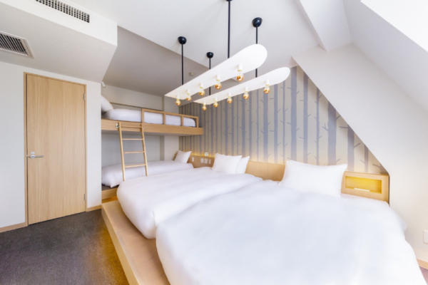 The Happo family hotel room - two beds and one bunk bed with feature lighting fixture | Happo Village, Hakuba