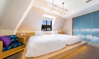 The Happo suite bedroom two beds, seating sofa, window and decorative sliding screen | Happo Village, Hakuba