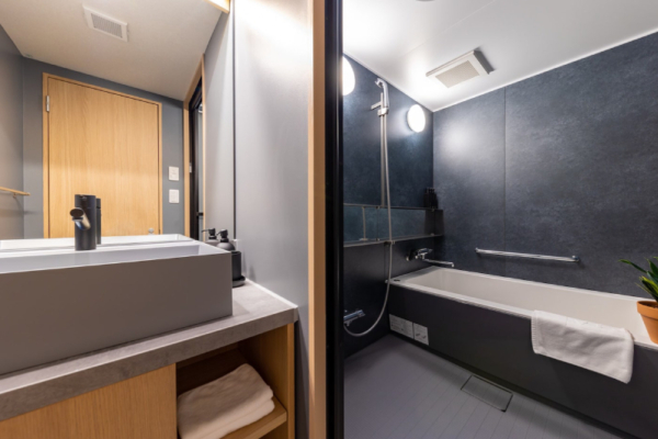 The Happo Suite en suite bathroom with bathtub, shower and washstand | Happo Village, Hakuba