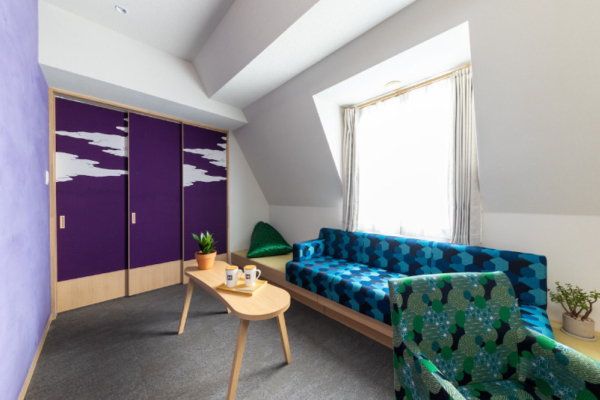 The Happo triple bedroom suite sofa seating area with coffee table, window | Happo Village, Hakuba