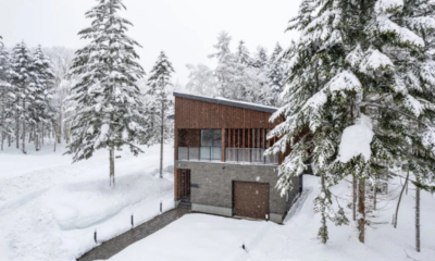 Jade Rabbit exterior daytime from front, heated entrance, balcony, slanted roof, forested surrounds | East Hirafu, Niseko