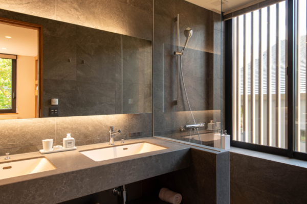 Yuzen fourth en suite bathroom with shower, washstands and grey tile | Kabayama, Niseko