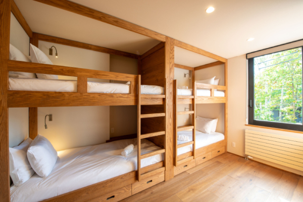 Yuzen fifth bedroom bunk room with four bunk beds, individual lighting nooks and underbed storage, window with forest views | Kabayama, Niseko