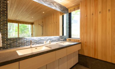 Yuzen feature shared bathroom with wood walls, changing area with washstands | Kabayama, Niseko