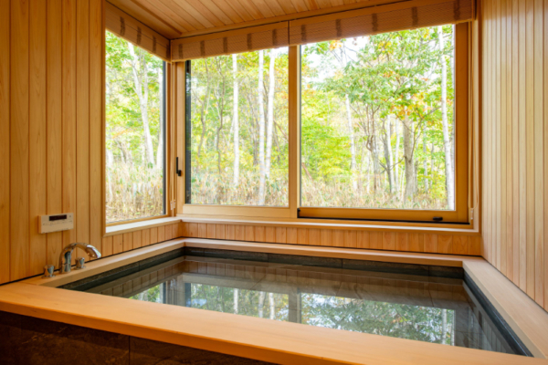 Yuzen feature shared bathroom with Japanese style wooden bath, forest views | Kabayama, Niseko